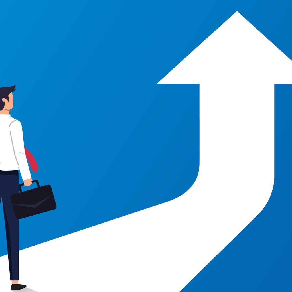 What is the long-term benefit of an MBA? Man in suit standing with arrow pointing up